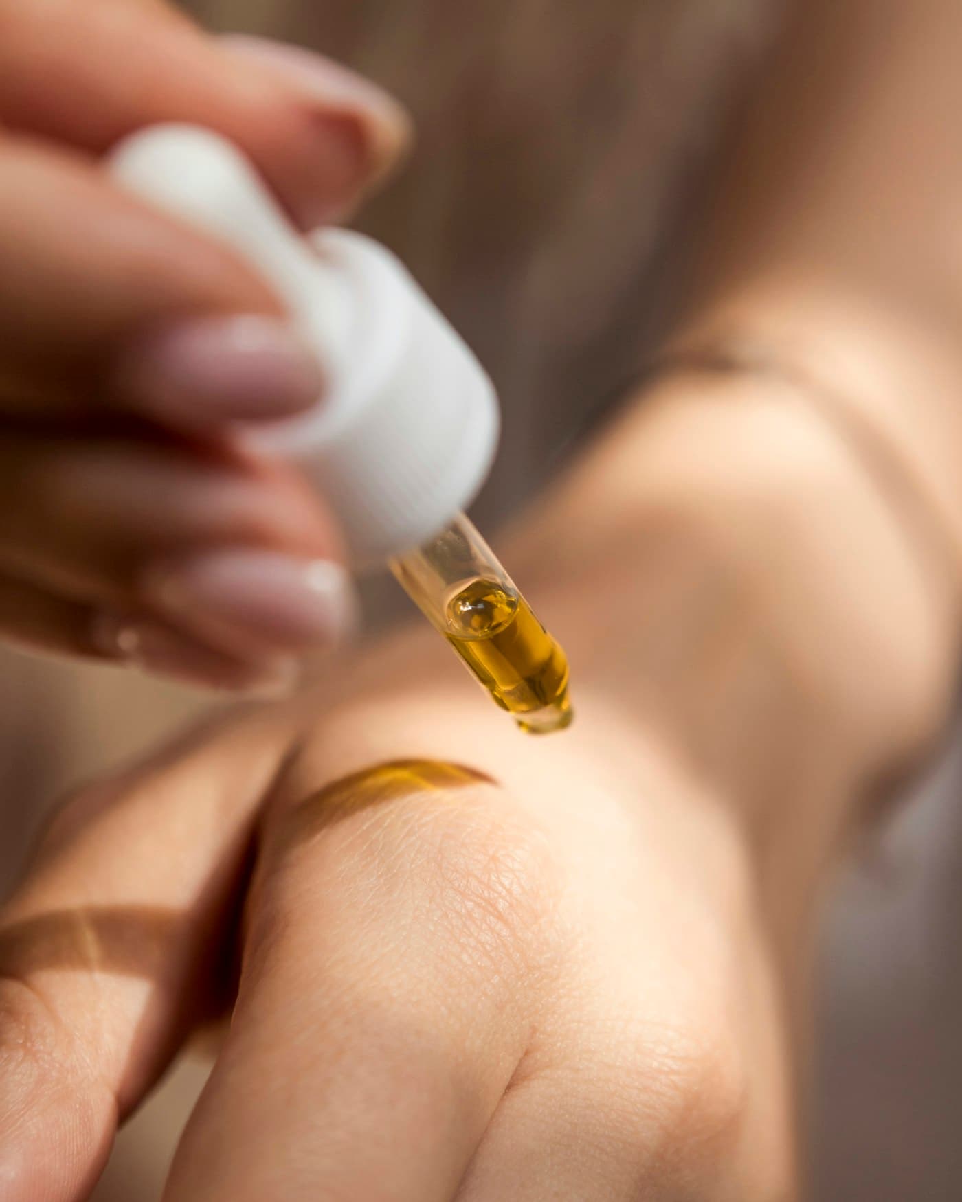 Golden facial oil on dewy skin